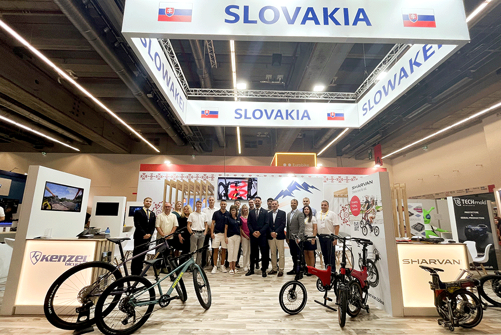 Group photograph of representatives of Slovak companies and SARIO at the Slovak national pavilion during EUROBIKE 2026 in Frankfurt am Main, in front of a display of bicycles and cycling solutions.