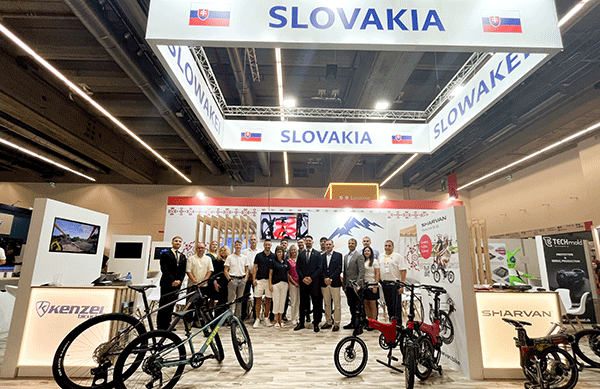 Group photograph of representatives of Slovak companies and SARIO at the Slovak national pavilion during EUROBIKE 2026 in Frankfurt am Main, in front of a display of bicycles and cycling solutions.